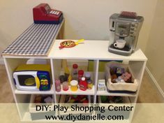 a toy kitchen and play center in a child's room