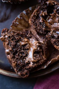 a chocolate muffin with frosting on a plate