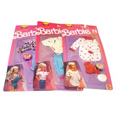 two barbie dolls are shown in their packaging for the first time, one is wearing clothes