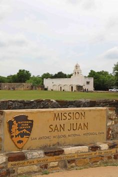 the mission san juan sign in front of an old building