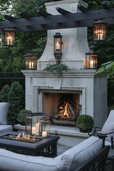 an outdoor fireplace with lit candles on it