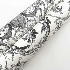 an image of a black and white wallpaper with floral designs on the back side