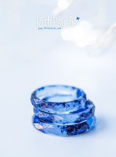 A beautiful blue faceted resin ring with metallic blue flakes inside. This resin ring is perfect for stacking! It's faceted all the way around and it is so comfortable to wear. All my resin rings are handmade with self-made molds. they are also hand-sanded and polished, to be smooth and comfortable to wear. Given the nature of the resin, my rings may contain tiny bubbles and imperfections, but I always try to make them as perfect as possible. The listing is for ONE stacking ring with metal flake Handmade Blue Resin Rings, Blue Resin Rings For Gifts, Blue Resin Rings Perfect For Gifts, Blue Resin Rings Perfect As Gifts, Blue Stackable Midi Rings For Gift, Blue Stackable Midi Rings As A Gift, Minimalist Blue Hypoallergenic Rings, Ring Resin, Simple Rings