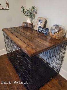 a wooden table with metal cage on top