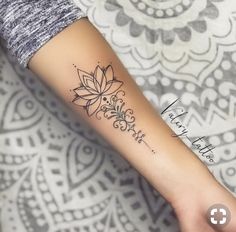 a woman's arm with a flower tattoo on the left side of her arm