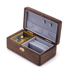 an open wooden box with a watch inside