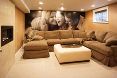 a living room filled with furniture and a large painting on the wall above it's fireplace