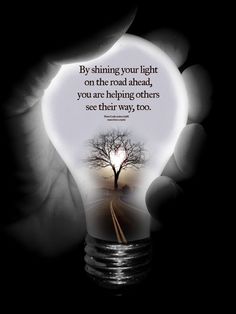 a person holding a light bulb with a tree inside it and the words by shining your light on the road ahead, you are helping others see their way, too