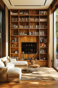 a living room filled with furniture and bookshelves next to a large sliding glass door