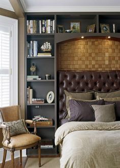 a bed room with a neatly made bed next to a book shelf filled with books