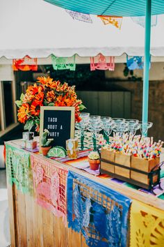 an outdoor party is set up with colorful decorations