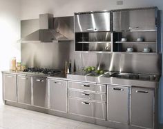 a kitchen with stainless steel appliances and cabinets