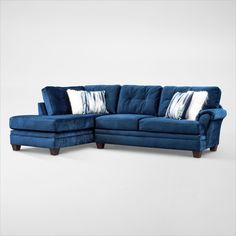 a blue sectional couch with pillows on it