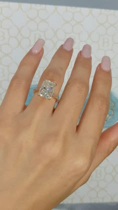 a woman's hand with a diamond ring on it