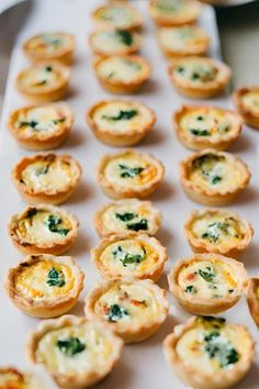 small appetizers with spinach and cheese on a white tablecloth, ready to be eaten