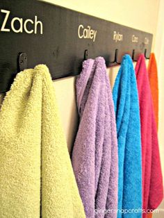 towels are hanging on the wall in front of each other