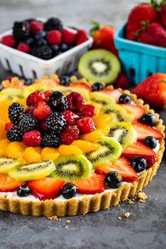 a fruit tart with berries, kiwis and strawberries