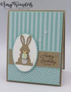 a handmade card with a bunny holding a birthday cake in it's lap