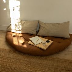 a brown couch sitting on top of a wooden floor