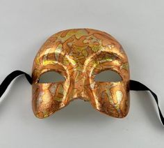 This Venetian half mask is perfect for any masquerade event.  Simple yet elegant.  The mask is handmade from paper mache and then decorated in variegated leaf. The mask's dimensions are approximately 6" wide, 5" high and 3 ½" deep. All masks are handmade in Venice, Italy.  No two masks are ever identical. Masquerade Event, Mask Half Face, Half Mask, Costume Masks, Half Face Mask, Half Face, Costume Mask, Venice Italy, Paper Mache