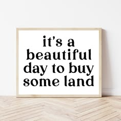 it's a beautiful day to buy some land in black and white on a wooden frame