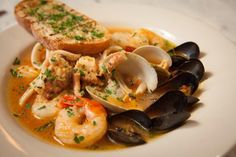 a white plate topped with pasta and clams