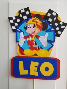 a mickey mouse birthday cake topper with the name leo on it