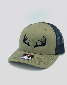 One of the most popular hats in the world, the Richardson 112, embroidered with a Deer Antlers. The Richardson 112 features a snapback closure and a mesh back. Available in several different hat colors and thread colors. We offer either the Richardson 112 in many colors or the Yupoong 6606 in greeen camo, both hats are snapback a one size fits all! Winter Flat Brim Trucker Hat For Outdoor, Winter Outdoor Trucker Hat With Flat Brim, Adjustable Trucker Hat For Winter, Winter Trucker Hat With Curved Brim, Winter Adjustable Trucker Hat, Adjustable Winter Trucker Hat, Adjustable Flat Bill Baseball Cap For Hunting, Casual Trucker Hat With Curved Brim For Hunting, Winter Trucker Cap