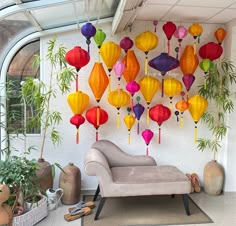 a living room filled with lots of colorful paper lanterns