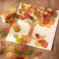 an autumn tree made out of leaves on a piece of paper