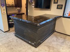 a large wooden box sitting in the middle of a room