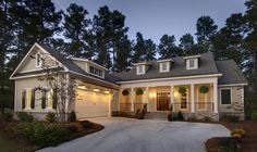 a large white house with two garages on the front and one story above it