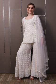 Off-white organza kurta with floral, thread and sequins hand embroidery. Comes with palazzo and a dupatta. - Aza Fashions White Silk Sets For Reception, White Silk Set For Reception, White Sequin Sets For Eid, Fitted Off White Palazzo Set With Dupatta, White Silk Sharara With Chikankari Embroidery, Designer White Silk Sharara, White Silk Sharara For Reception, Elegant White Palazzo Set For Festivals, Fitted Off White Sharara With Sheer Dupatta