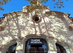 the entrance to teatre moudial is shown in front of a blue sky