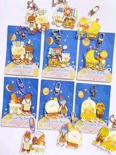 many different key chains are shown on a white surface with blue and yellow tags attached to them