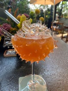 an orange drink sitting on top of a table