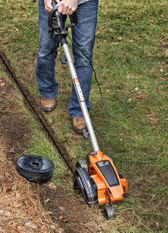 a man is using a lawn mower to cut the grass