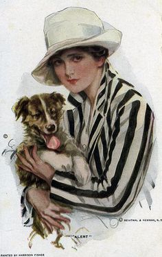 a woman holding a small dog in her arms while wearing a striped shirt and hat