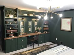 a bedroom with green cabinets and desk area