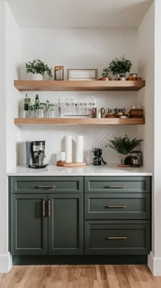 a kitchen with green cabinets and wooden shelves