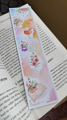 an open book with watercolor drawings on it