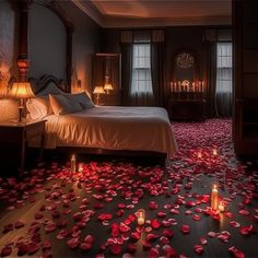 a bedroom with rose petals on the floor and candles in the room next to it