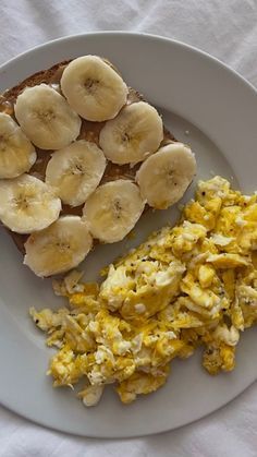 scrambled eggs, toast and bananas on a plate