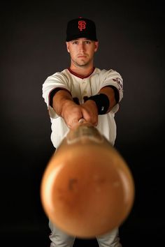 a baseball player holding a bat in his hands