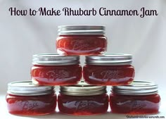 a stack of jars filled with jam sitting on top of a white tablecloth next to the words how to make rhubarb cinnamon jam