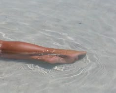 a woman laying in the water on her stomach