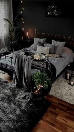 a bed room with a neatly made bed and candles