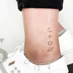 a woman's ankle tattoo with three sun and moon designs on her left side