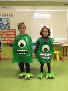 two children dressed up in costumes standing next to each other