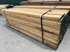 several stacks of wooden planks stacked on top of each other